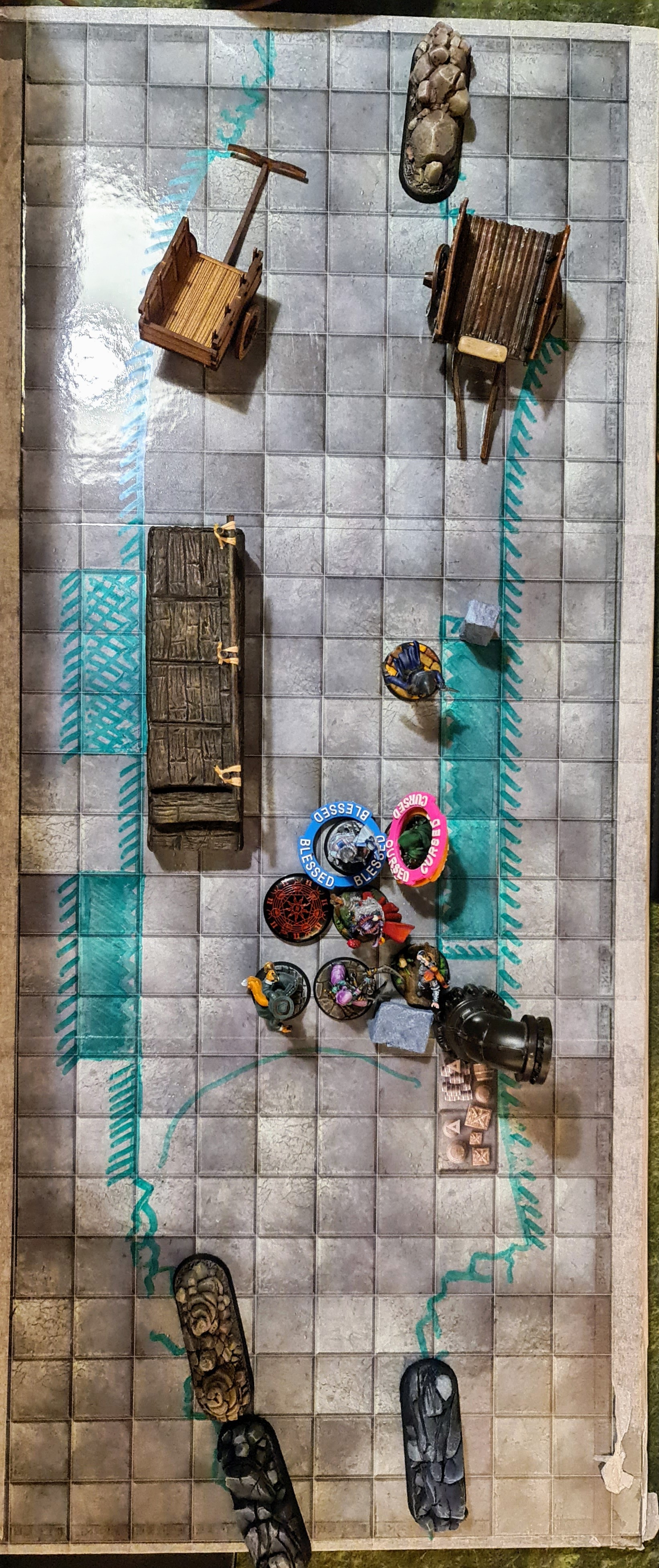 Birds eye view of a battle map showing terrain and miniatures